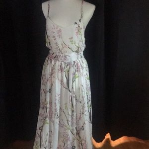 This a long dress that has branches with flowers